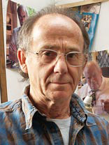 artist don faulkner wearing blue open neck shirt in own studio with images in the background